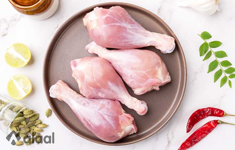 Raw chicken drumsticks, seasoned with aromatic spices